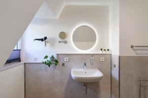 a bathroom with a sink and a mirror at Ferienhaus Berger 2025 in Bad Karlshafen +69 photos