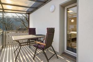 a table and chairs on a balcony with a view at Ferienhaus Berger 2025 in Bad Karlshafen