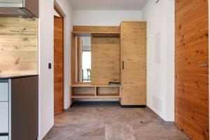 a room with a closet with wooden doors at Baumannhof Villnöß in Funes +99 photos