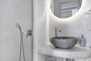 a bathroom with a stone sink and a mirror at Nicolas House 4 in Rakhídhion
