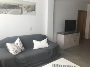 a living room with a couch and a television at Ferienwohnung, 110qm in Hohen Wangelin