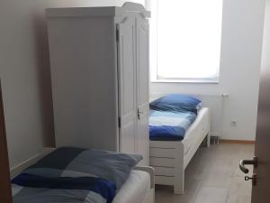 a bedroom with two beds and a window at Ferienwohnung, 110qm in Hohen Wangelin