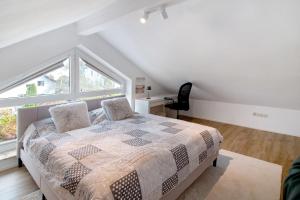 a bedroom with a bed and a large window at Fewo Christi in Weißensberg