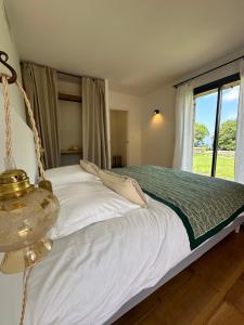 a bedroom with a swinging bed with a window at Chambres d'hote Bergerie A Maredda in Murato