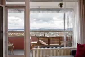 a room with a large window with a view of the city at Weitblick in Uhldingen-Mühlhofen