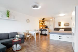 a living room with a couch and a bed at Weitblick in Uhldingen-Mühlhofen +18 photos