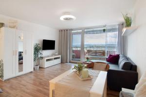 a living room with a couch and a table at Weitblick in Uhldingen-Mühlhofen
