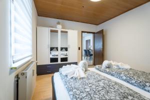 a bedroom with two beds and a window at Evin's Apartment in Kehl am Rhein