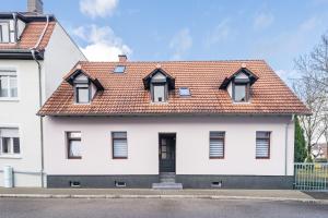 a white house with a red roof at Evin's Apartment in Kehl am Rhein