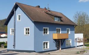 a blue house with a brown roof at wohnung-nummer-4 in Pielenhofen
