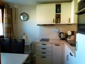 a kitchen with white cabinets and a counter top at Ferien Auf Dem Steingrubenhof in Sankt Peter