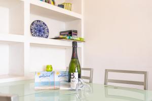 a bottle of wine sitting on a glass table at Casa Yves in Tossa de Mar +17 photos