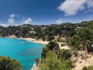 a view of a beach with houses on a hill at Casa Yves in Tossa de Mar