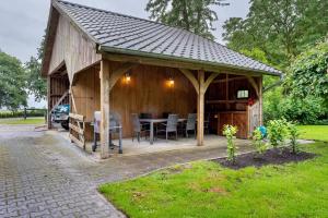 a wooden pavilion with a table and chairs at Grodenhof in Norderschwei