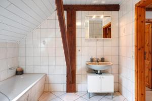 a bathroom with a sink and a bath tub at Grodenhof in Norderschwei