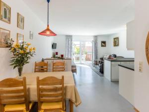 a kitchen and dining room with a table and chairs at Haus Fanjak in Uhldingen-Mühlhofen +18 photos