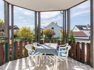 a patio with a table and chairs on a balcony at Haus Fanjak in Uhldingen-Mühlhofen