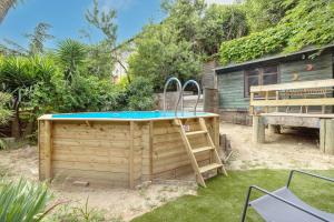 a swimming pool in a yard next to a house at Petite maison de bois in Banyuls-dels-Aspres +13 photos