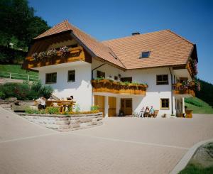 a large white house with people sitting outside of it at Stulzenhof in Hofstetten