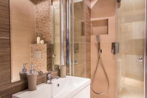 a bathroom with a sink and a shower at Gertrudy Old Town Apartments in Kraków +85 photos