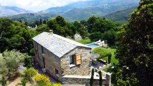 an aerial view of a stone house in the mountains at Chambres d'hote Bergerie A Maredda in Murato +41 photos
