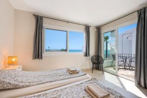 a bedroom with a bed with a view of the ocean at Rocas del Mar in Mijas +23 photos