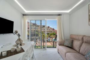 a living room with a couch and a table at Granada Park S01A in Arona