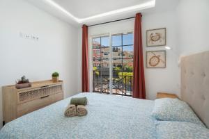 a bedroom with a bed and a large window at Granada Park S01A in Arona +21 photos