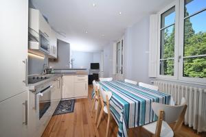 a kitchen with a table and chairs in a room at Le Clos du Casino in Luchon