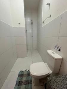 a white bathroom with a toilet and a shower at Modelo Prime Hotel in Ribas do Rio Pardo +17 photos