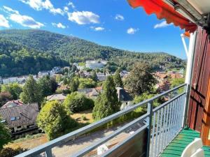a balcony with a view of a town and mountains at Ferienwohnung Adrion in Bad Herrenalb