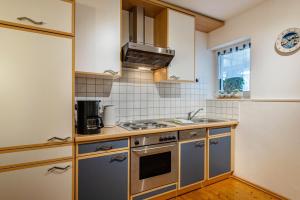 a kitchen with a sink and a stove top oven at Haus Gisela - Stockkamp in Todtmoos +37 photos