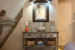 a bathroom with a sink and a mirror at Demeure D'antan - Chambres d'hôtes in Beblenheim +54 photos