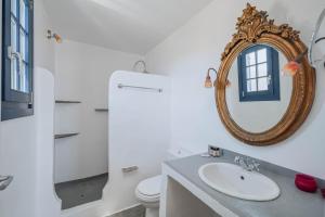 a bathroom with a sink and a mirror at Villa Agios Sostis in Serifos Chora +37 photos