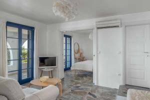 a living room with a couch and a tv at Villa Agios Sostis in Serifos Chora