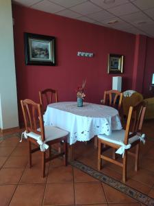 a dining room table with a white table cloth and chairs at Can Joan in Rosell +9 photos