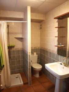 a bathroom with a toilet and a sink at Can Joan in Rosell