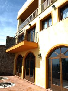 a building with a balcony on top of it at Can Joan in Rosell