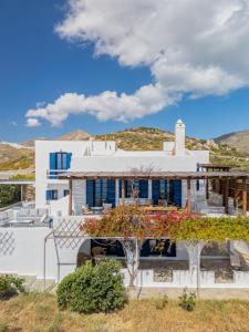 a white villa with a view of the mountains at Villa Agios Sostis in Serifos Chora