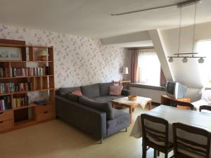 a living room with a couch and a table at Ferienhof Rosenwarft in Pellworm