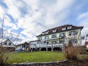a large house with a slide in front of it at Gasthof Adler in Ebenweiler