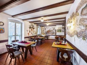 a restaurant with tables and chairs in a room at Gasthof Adler in Ebenweiler