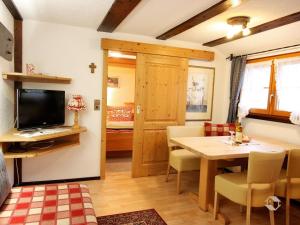 a living room with a dining table and a bedroom at Erlenhof in Todtnau