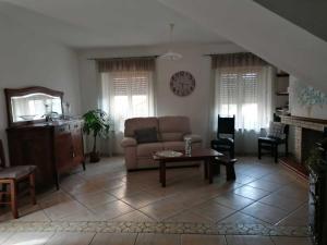 a living room with a couch and a table at Casa vacanze Bau Mela in Villanova Strisaili