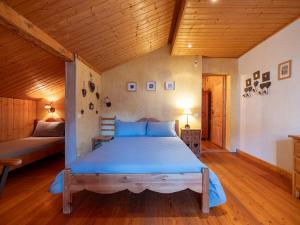 a bedroom with a bed and a wooden ceiling at Les Grands Champs Sud in Faverges