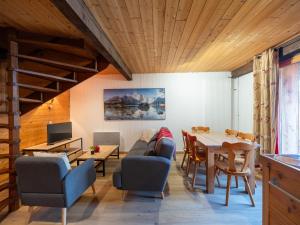 a living room with a couch and a table at Les Grands Champs Sud in Faverges
