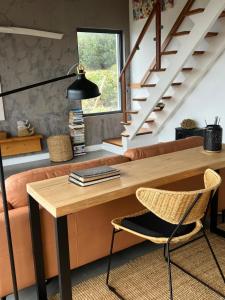 a living room with a wooden table and a couch at Casa da Arquinha in Santo Amaro