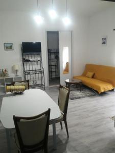 a living room with a table and chairs and a couch at Gradina Bulgarana in Bourg-Argental