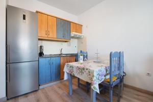 a kitchen with a table and a refrigerator at Casa Tanai in El Cotillo