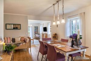 a dining room and living room with a table and chairs at Lina in Rottenbuch